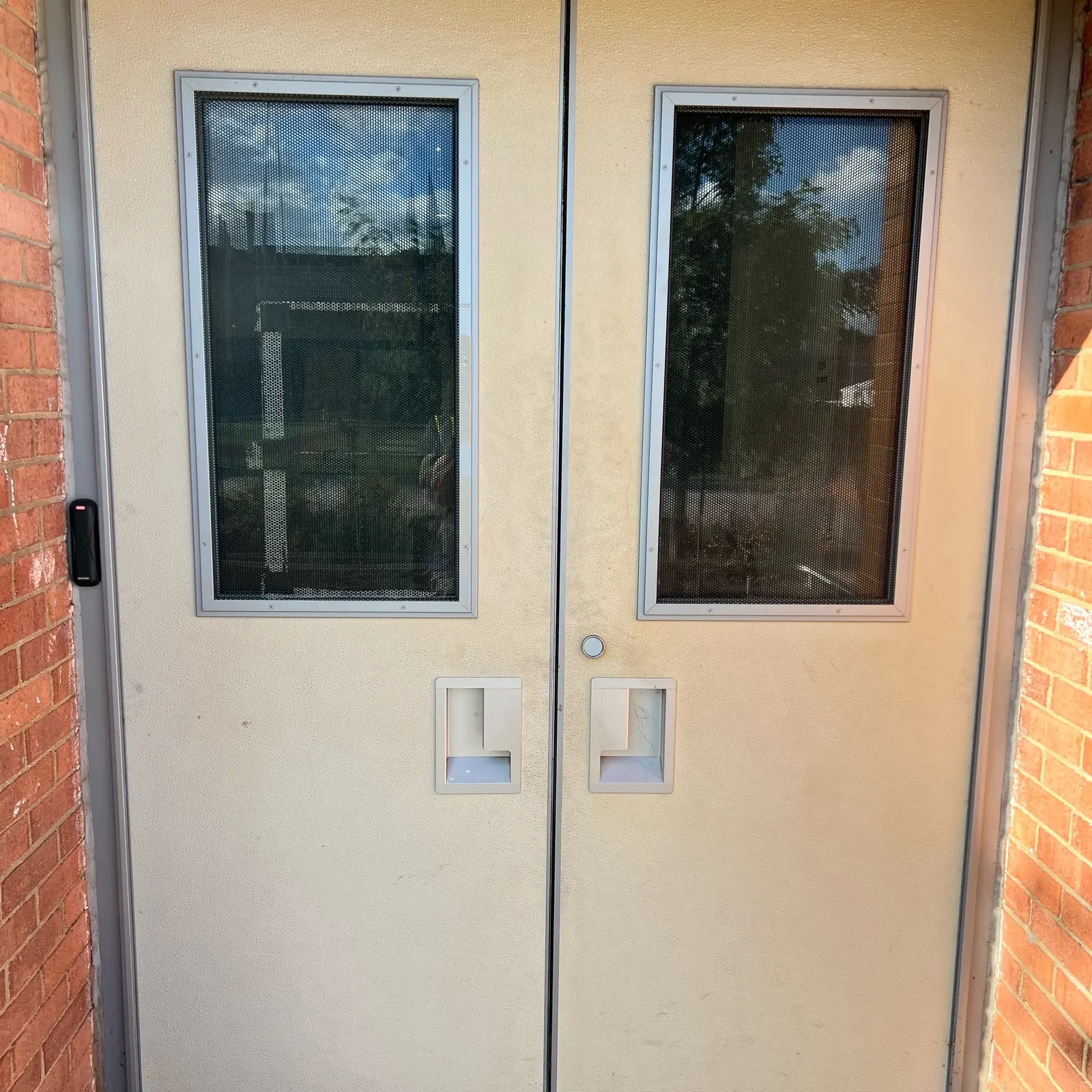 Commercial double doors with vision panels and access control reader in Washington DC