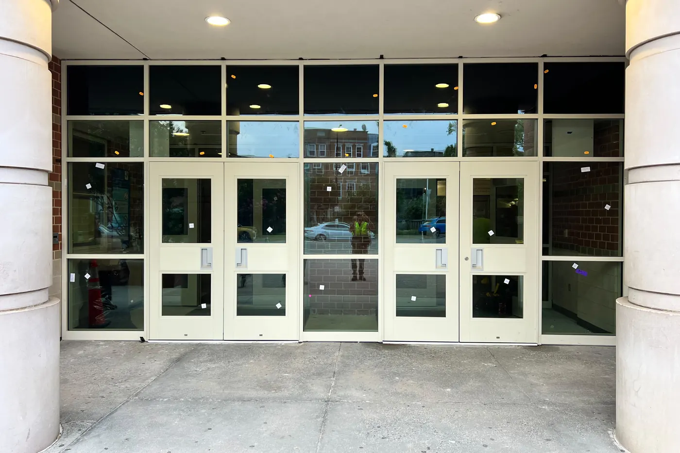 Two pairs of commercial entrance doors with glass sidelights and transoms at a building entrance in Washington DC